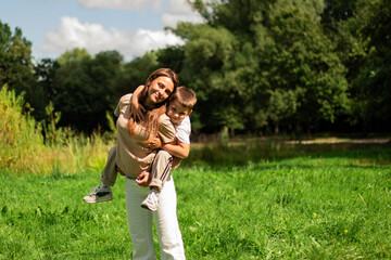 Six years old boy and his mom twirl together and laughing. Heartwarming display of mother son fun and connection.