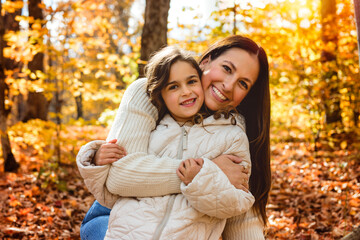 Fototapeta premium mother with four years girl in autumn beautiful forest