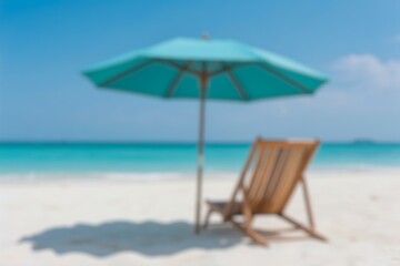 Obraz premium Beach chairs and umbrella by the turquoise ocean on a sunny tropical day. Blur background 