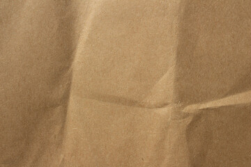 Brown crumpled kraft paper texture with deep folds and creases