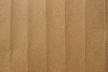 Fototapeta premium Brown crumpled kraft paper texture with deep folds and creases