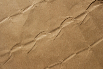 Brown crumpled kraft paper texture with deep folds and creases