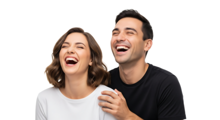 A man and a woman are laughing, as the man places his hand on the woman's shoulder. They seem very happy together.
