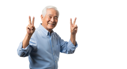 Senior man with bright smile, making victory gesture with two fingers against a transparent background, in a light blue shirt.