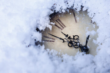 Snowy antique clock, Faded winter clock in snow, Silent snowcovered clock illustrating time