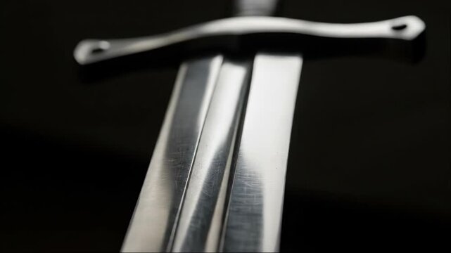 Animated close-up of medieval sword rotating. Fantasy blade with crossguard in motion. Digital weapon concept for games and adventure stories.