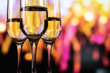 Champagne glasses amid night fireworks, Celebrating New Year with sparkling drinks and fireworks