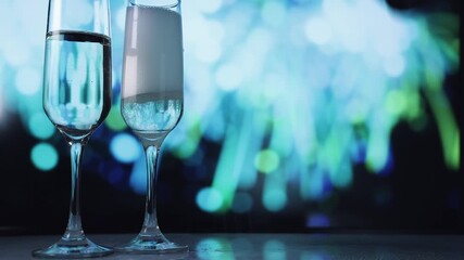 Two champagne flutes against cool blue bokeh - Powered by Adobe