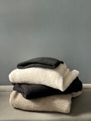 Minimalist Winter Wardrobe Concept — Knitwear Stack, Scandinavian Style Cozy Folded Clothes