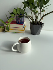 Cozy Workspace with Cup of Tea and Indoor Plant – Minimal Home Office with Green Plant and Warm Light