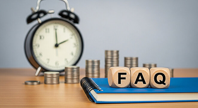 Faq wooden blocks sit atop a blue notebook with coins and a clock in the background representing financial questions and time management