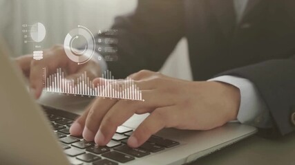 businessman typing on laptop with data graph chart overlay analyzing business data and technology analytics in digital workspace using keyboard in modern workspace - Powered by Adobe