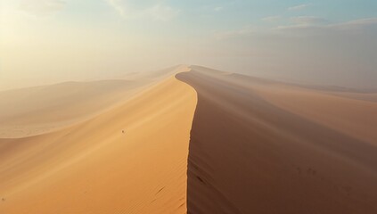 Spanning sand dune crest forming curved ridge across remote desert landscape, with wispy clouds