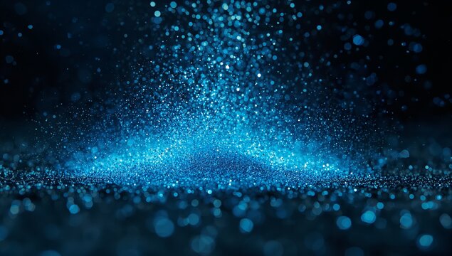 Mound of glowing blue particles rising and scattering in dark studio, with reflective surface