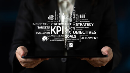 A business professional presents a tablet showing a graphic diagram of KPIs, focusing on...