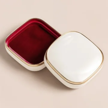 Open elegant gift box showing red velvet interior and gold foil