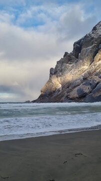 Scenic view of the winter  landscapes at Bunes Beach on a  with the mountains in the background on Lofoten Islands in Norway.

