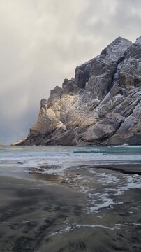 Scenic view of the winter  landscapes at Bunes Beach on a  with the mountains in the background on Lofoten Islands in Norway.

