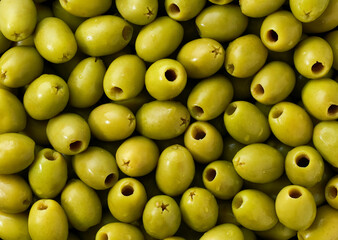 pitted olives close-up. Background of pitted olives.Top view. pickled pitted green olives close up.