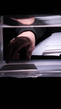 vertical video Hand placing letter into mailbox for sending or receiving communication