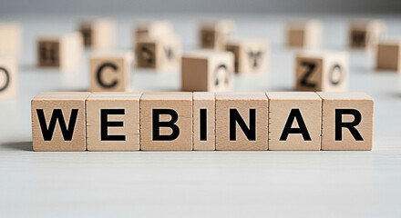 Wooden blocks spelling webinar on a white surface promote online events and educational opportunities for business and personal development