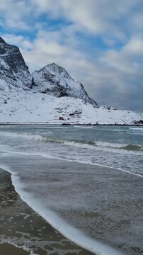View of amazing sandy Bunes beach with sea and mountains in winter, Lofoten Islands, Norway

