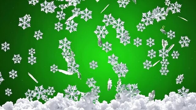Snowflakes gently falling in front of a green screen.