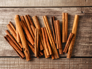 Cinnamon sticks spice on rustic wooden table background. Top view. Design element. Selective focus.