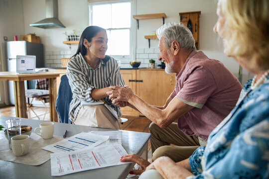 Senior couple with counselor at home