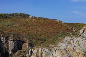Nature trail along the Cantabrian Route toward Portocelo and Viveiro. Two hikers walk along the Galician coast in Xove, Lugo. Mariña Lucense, Galicia.