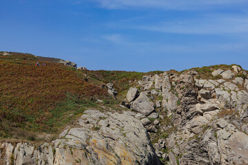 Nature trail along the Cantabrian Route toward Portocelo and Viveiro. Two hikers walk along the Galician coast in Xove, Lugo. Mariña Lucense, Galicia.