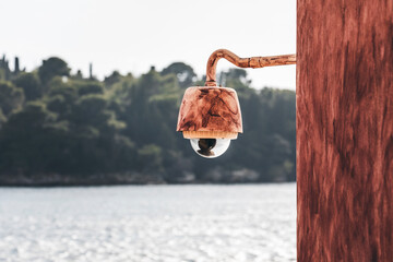 lamp in front of the seascape in rovinj and the view on the small island with trees