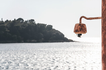 lamp in front of the seascape in rovinj and the view on the small island with trees with clear light