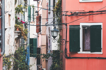 colorful windows and walls with lamps and flowers in rovinj