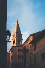 town of montona in istria, croatia, at golden hour with warm light on the bell tower 