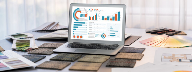 Interior designer workspace table and architecture software on laptop screen with mood board...