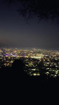 Person Overlooking City Lights at Night