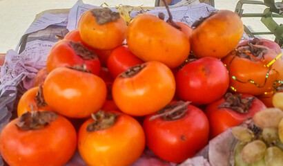 Vibrant Orange Persimmons on Display at a Market