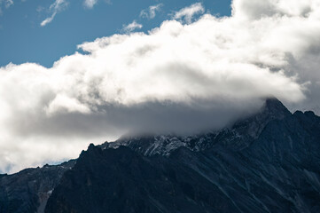 A plateau peak shrouded in clouds at its summit