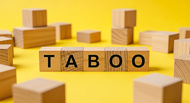 Wooden blocks spelling taboo on a bright yellow background create a visually striking concept for sensitive subjects and forbidden topics