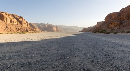 The panoramic sweep of a wide, gravel-filled wadi.