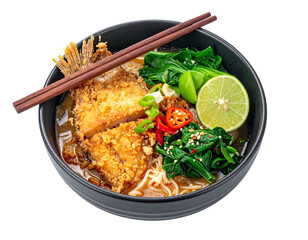 A close-up of a noodle bowl with crispy fried topping, greens, chili peppers, and lime, viewed from above on black