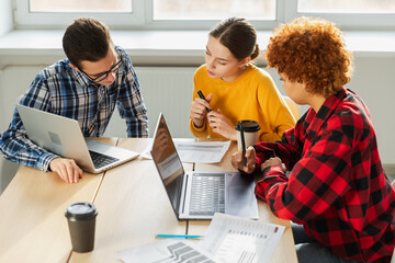 Teamwork brainstorm. Diverse colleagues working together discuss financial statistics. Group of...