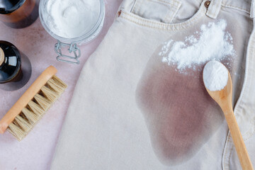 Dirty red wine stain on light denim jeans ready for cleaning with natural ingredients in a home...
