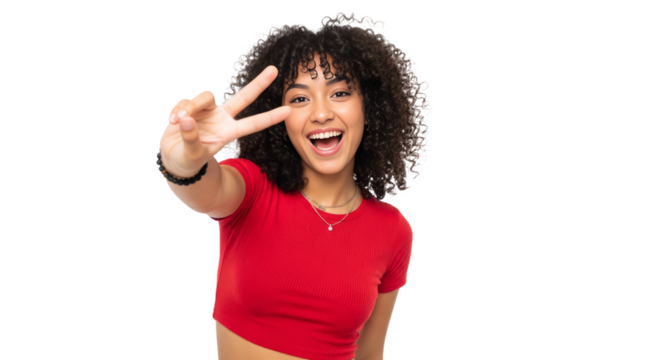 Latina teenager with curly hair shows playful spirit with a peace sign against bright background