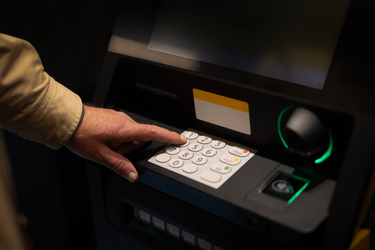 Hand enter pin security number at ATM machine