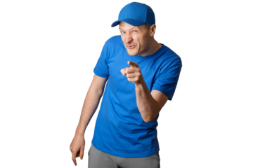 Smiling man in a blue shirt and cap playfully pointing at the camera with a cheeky expression.