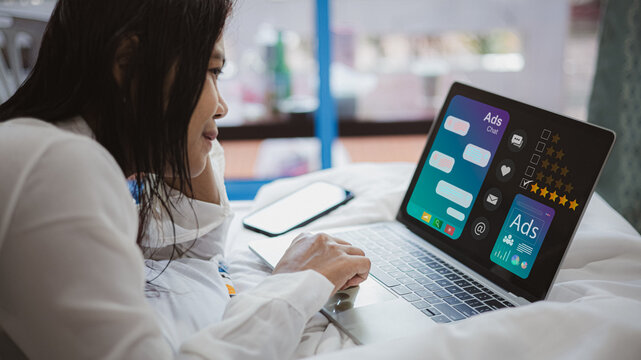 Woman using laptop for online advertising, digital marketing and social media communication concept - Powered by Adobe