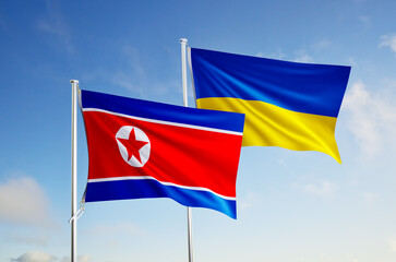 flags of ukraine and north korea over blue sky background.