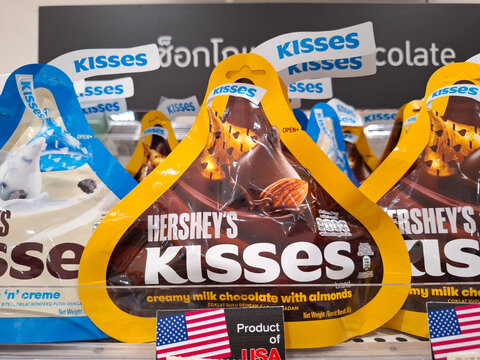 Hersheys Kisses Creamy Milk Chocolate with Almonds Packaging Displayed for Sale on Retail Store Shelf with American Flag on October 24, 2025 in Bangkok, Thailand